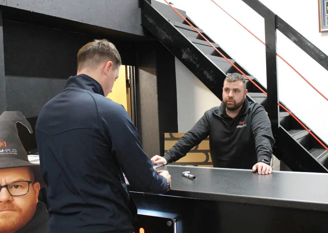 Aaron from Warm-Flo talking to a customer in the showroom.